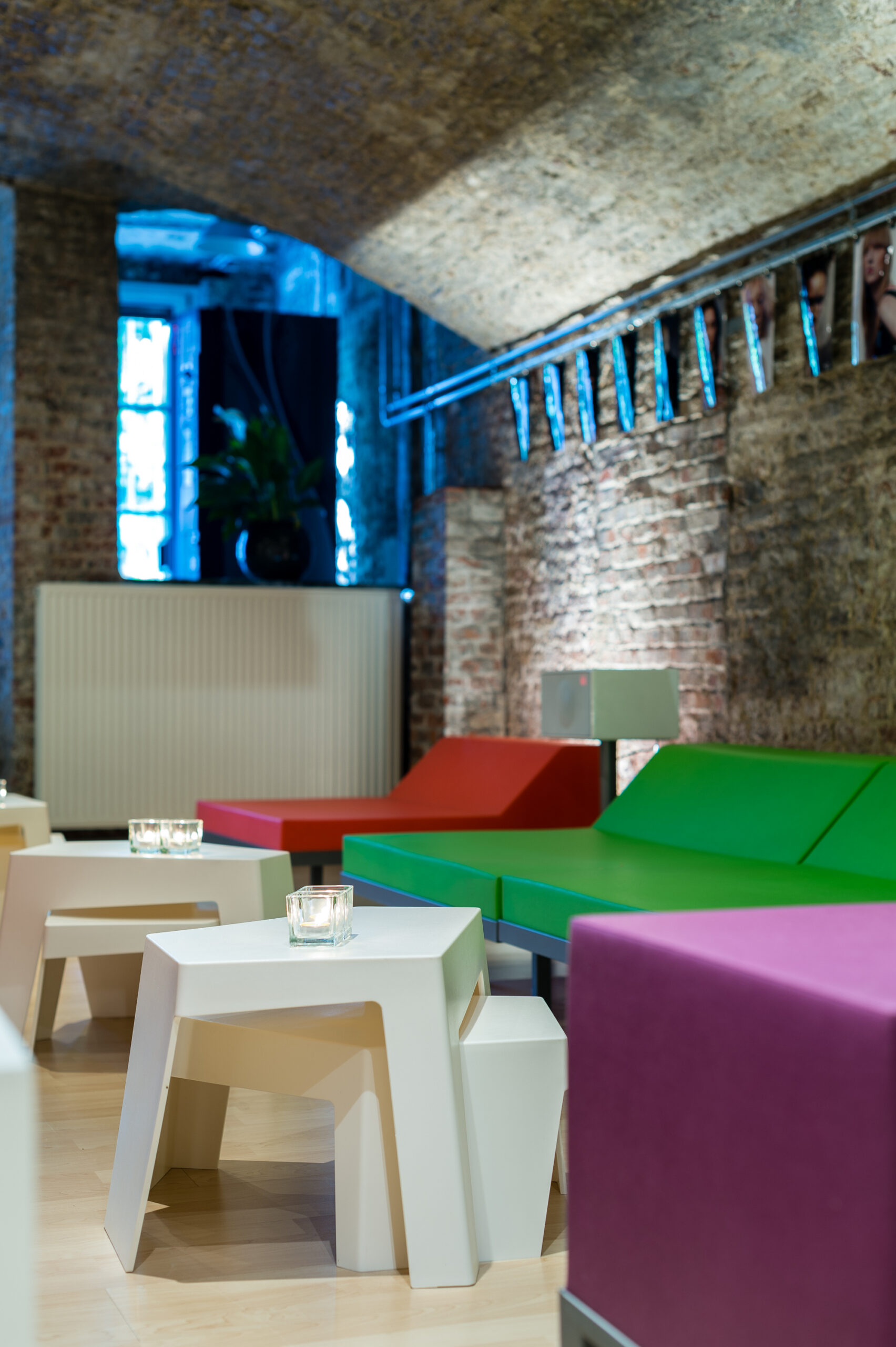 Colourful M² seating in a vaulted hospitality interior